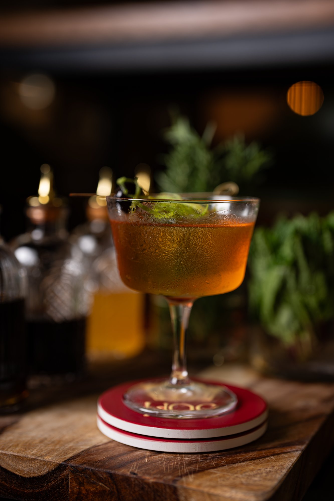 Pookosu Karuvepilai Melagu HOC signature cocktail on HOC branded coaster